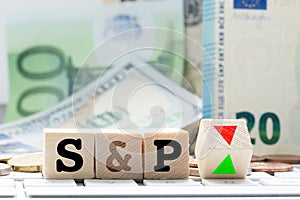 S&P, Standard and poorÃ¢â¬â¢s rating adjustment concept, with euro banknotes in background photo